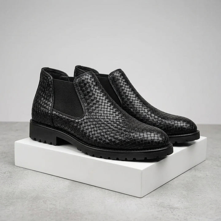 Black shoe with a strap on a white background